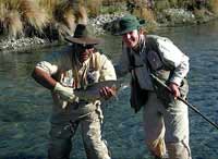 Another happy fly fisherman lands a trout in New Zealand.