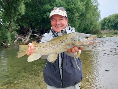 Trout hooked by anglers fly fishing in the lakes and rivers at the foot of the Southern Alps in New Zealand.